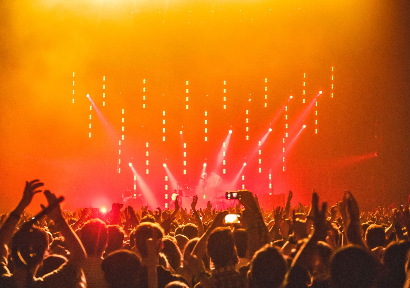 Festival crowd cheering under stage lights